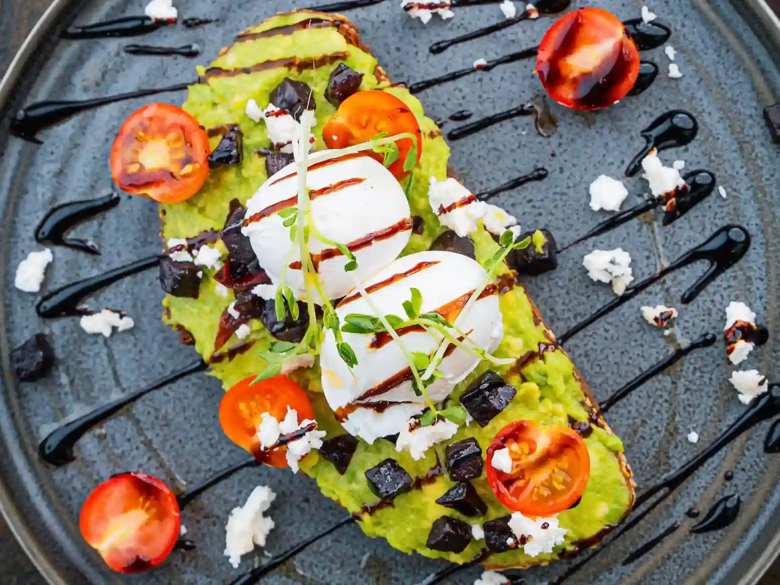 Smashed avocado toast with poached eggs